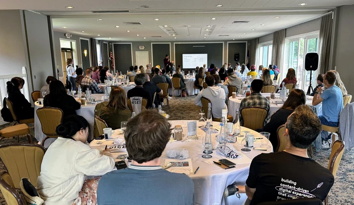 Conference room of engaged peers listening to a presentation